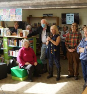 Lots of Historical Society members were there! We appreciate Brian taking pictures. Group of people standing and watching presentation at a library