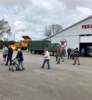 Part of the group... intent on the next building. There were 17 of them! group of people walking outside on a guided tour through historic collection